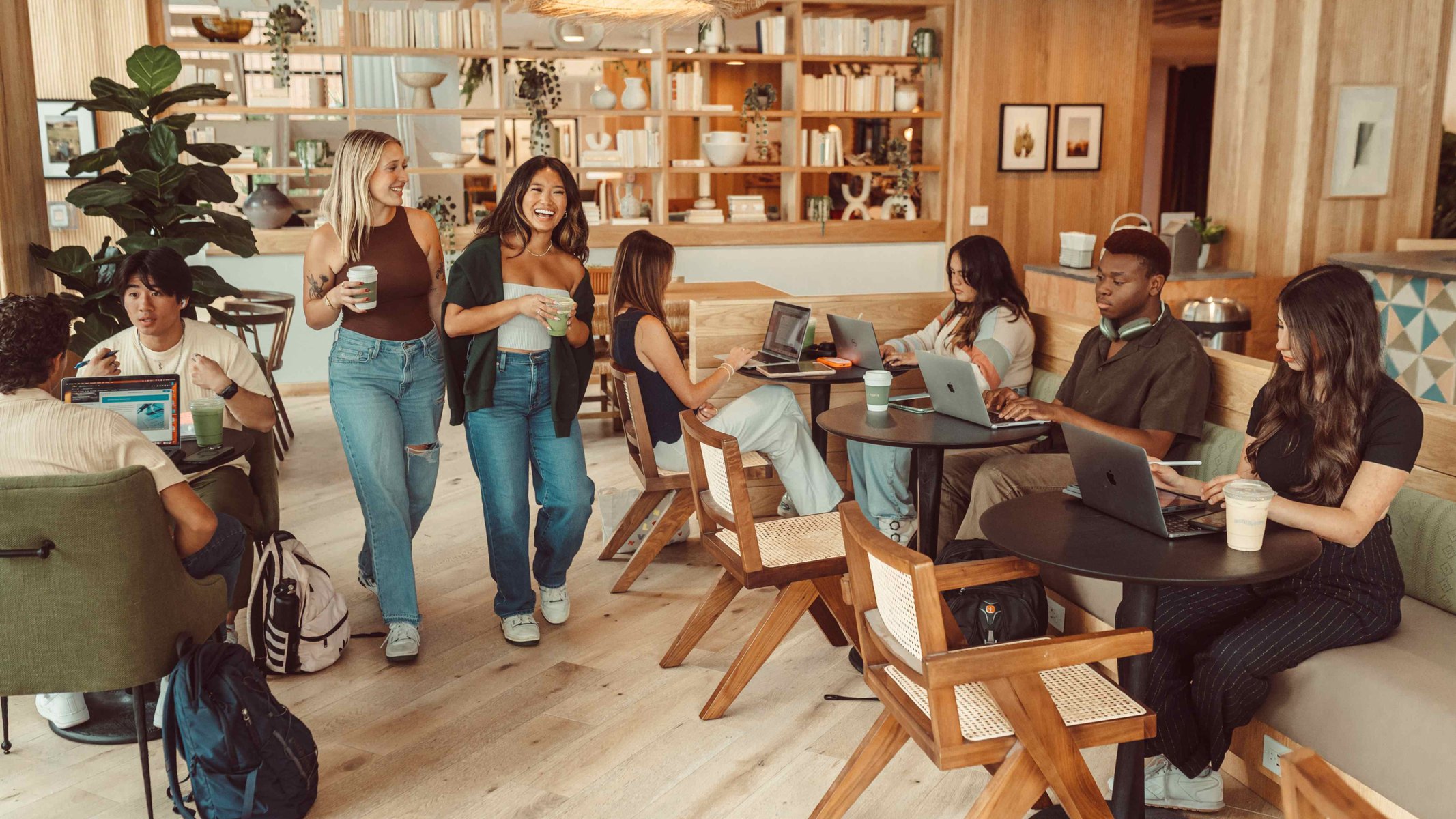 Girls walking through bustling Rambler Daydreamer Cafe
